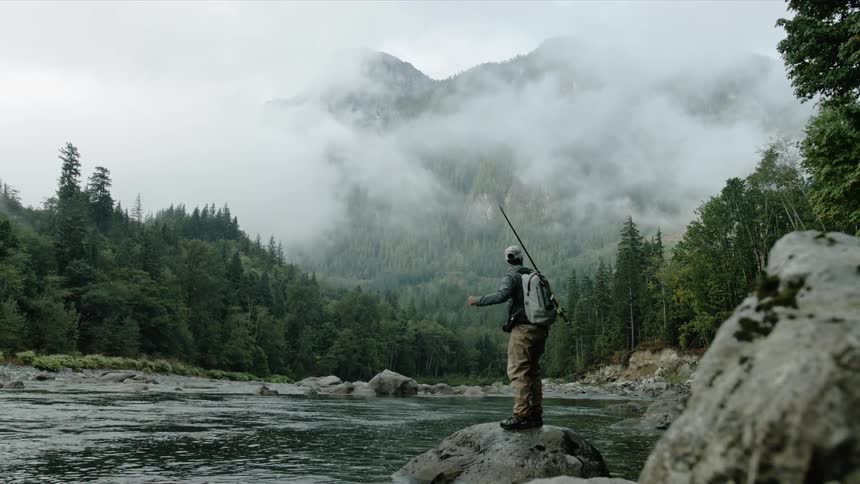 A man fishes in a stream