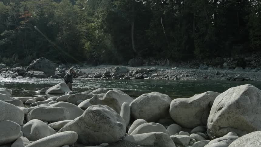 A man fishes in a stream