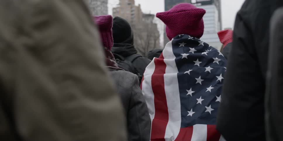 Protesters march down a city street