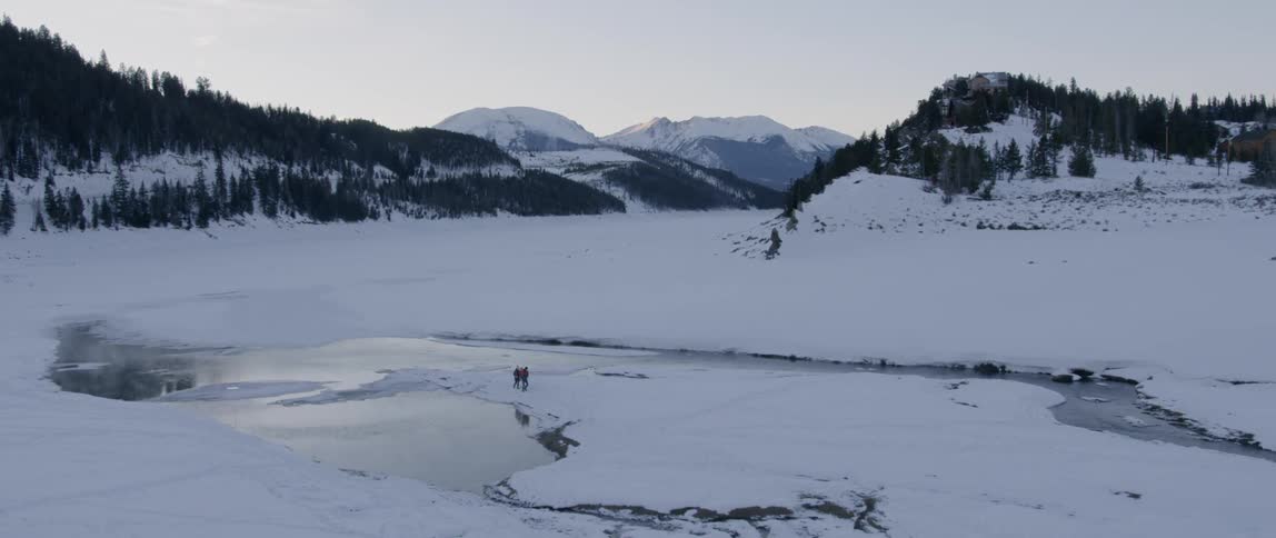 A family walks together in the snow