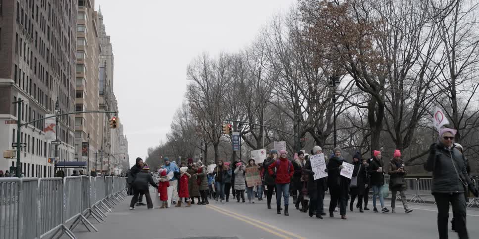 A group of protesters march down the road