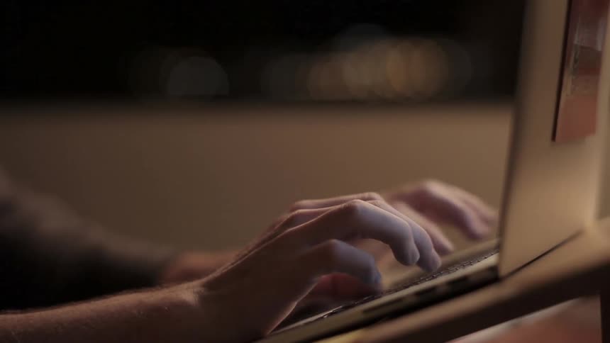 Person types on a laptop