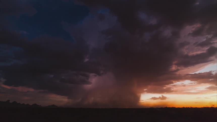 An isolated thunderstorm at sunset over the desert