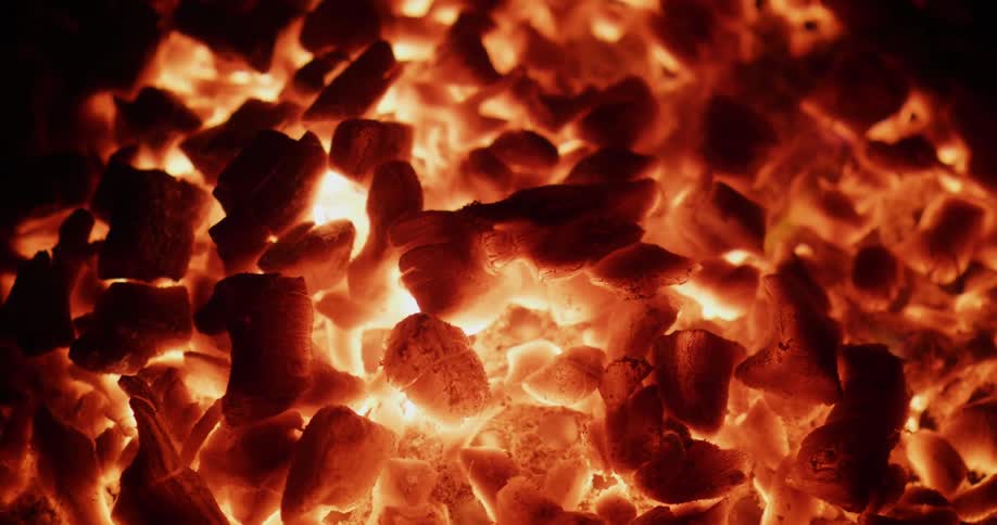 Coals glow orange as they burn