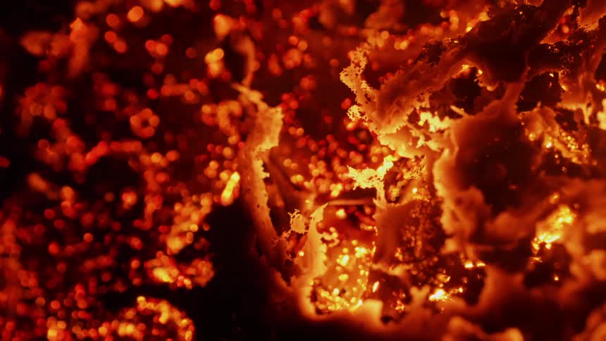 Embers glow as they burn in the dark