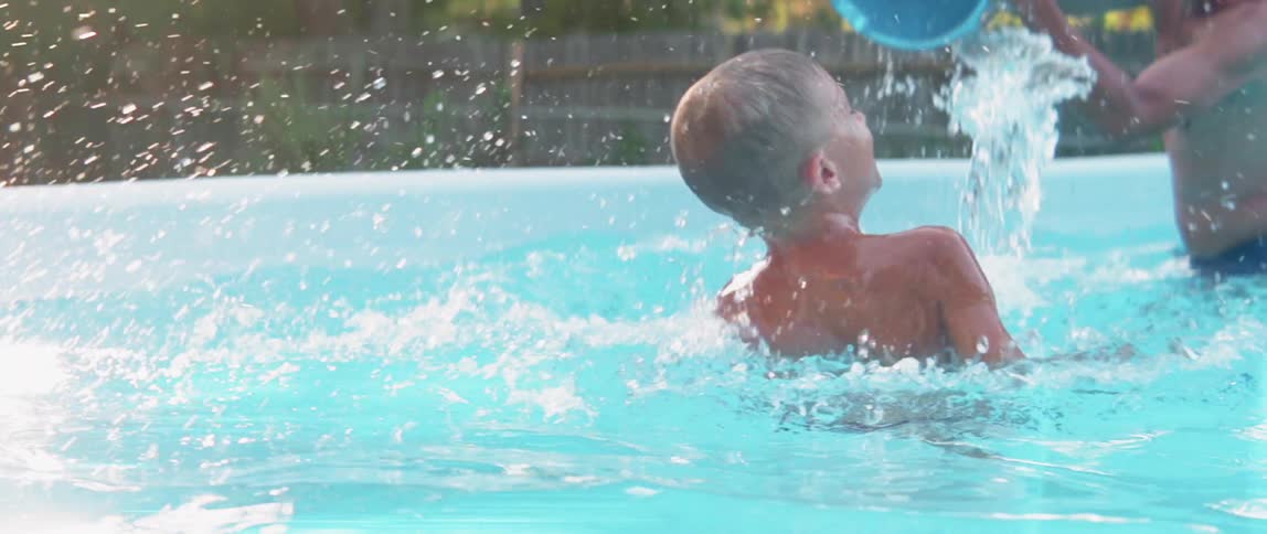 Children splash and play in a pool