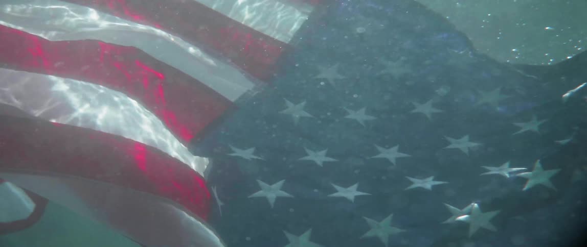 An american flag falls into the water