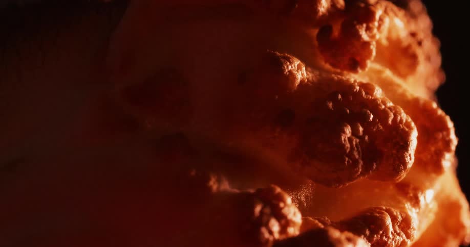 The orange surface bubbles and expands as it heats