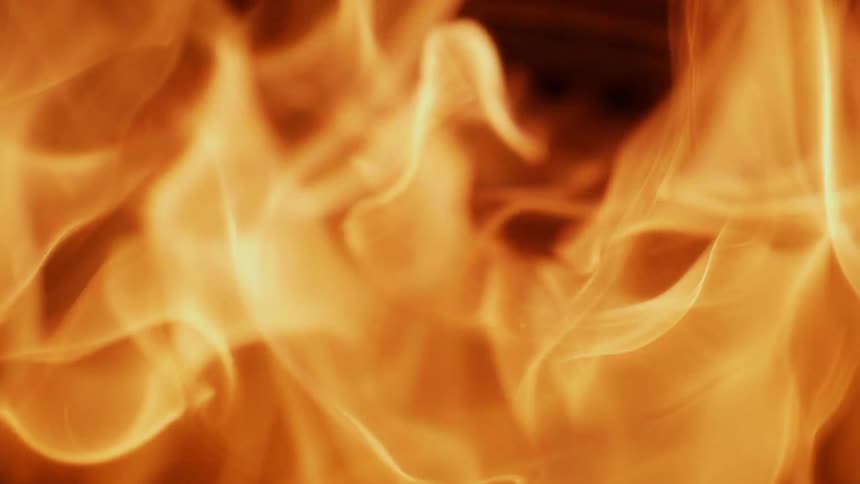 A fire burns in the dark