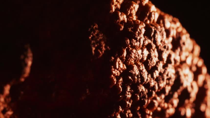 The orange surface bubbles and expands as it heats