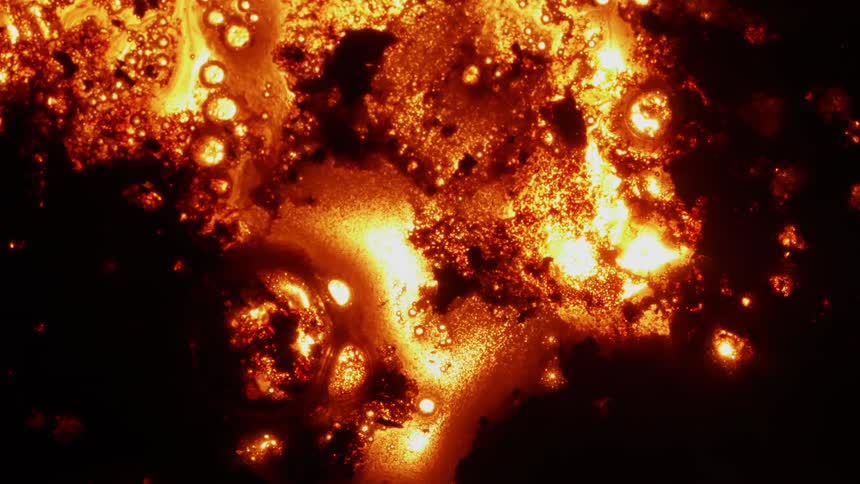 Liquid bubbles and flows as it heats and glows
