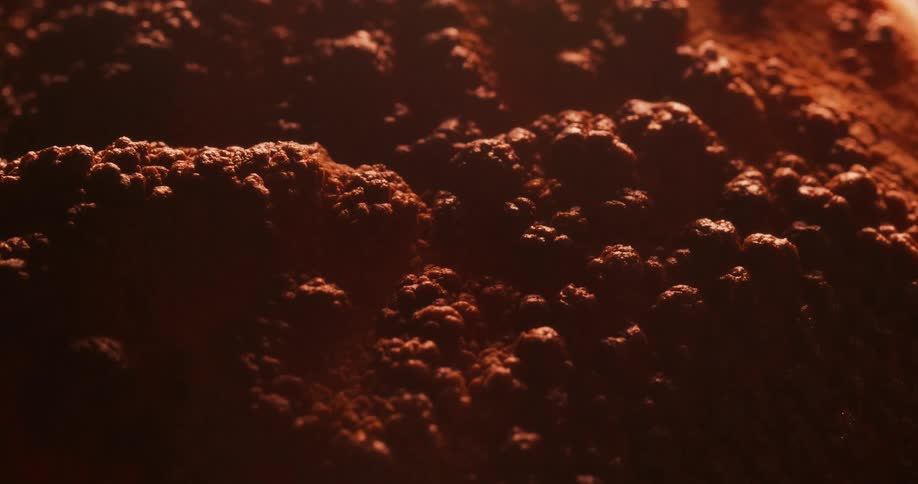 The orange surface bubbles and expands as it heats