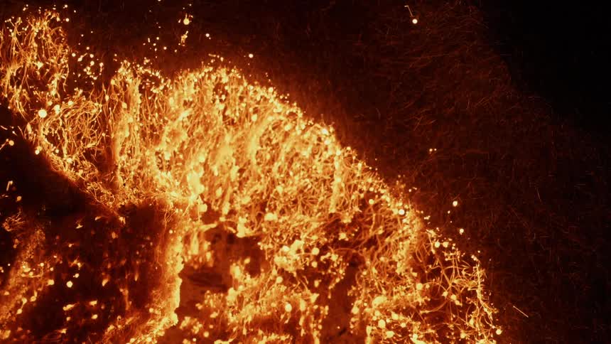 A fire ignites and lights the kindling