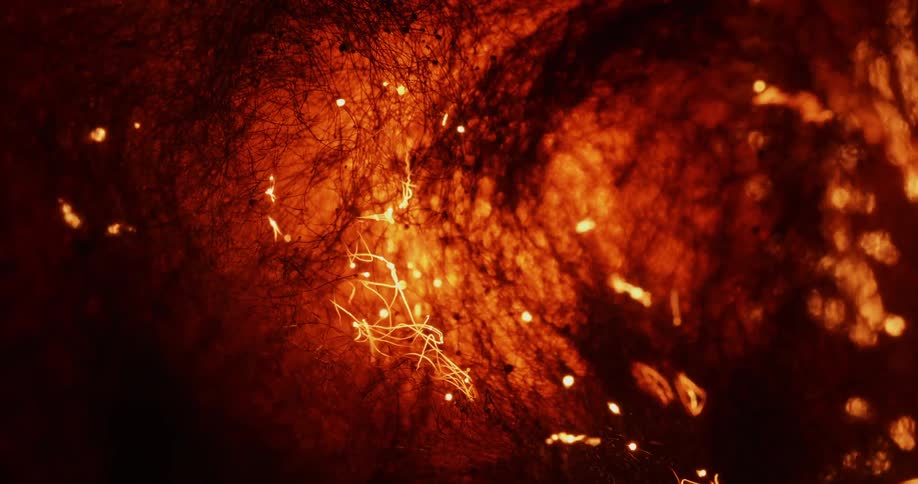 Fibers spark and fly as it heats and burns