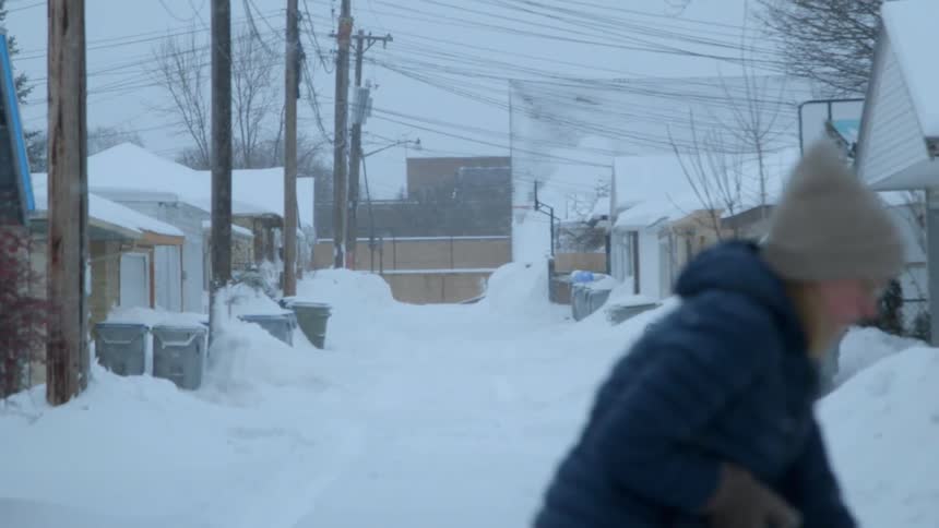A woman shovels during a snowstorm