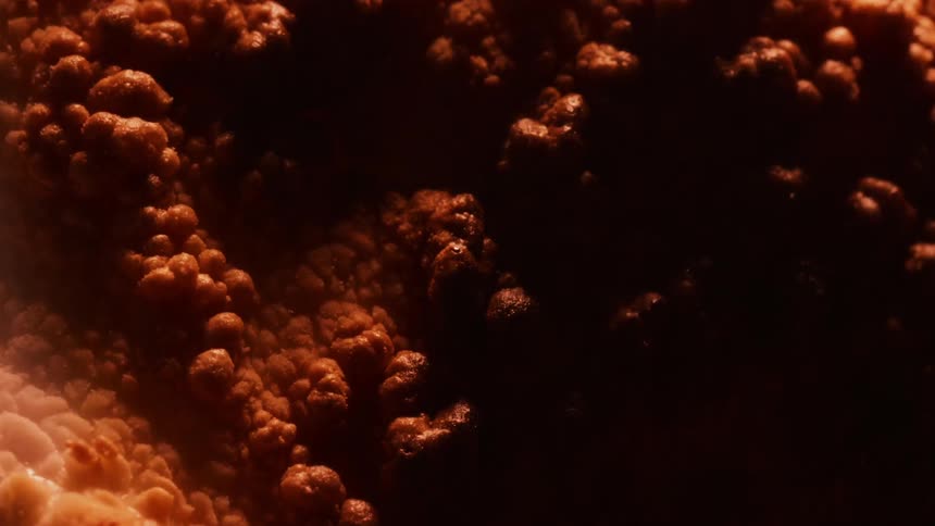 The surface bubbles and expands as it heats