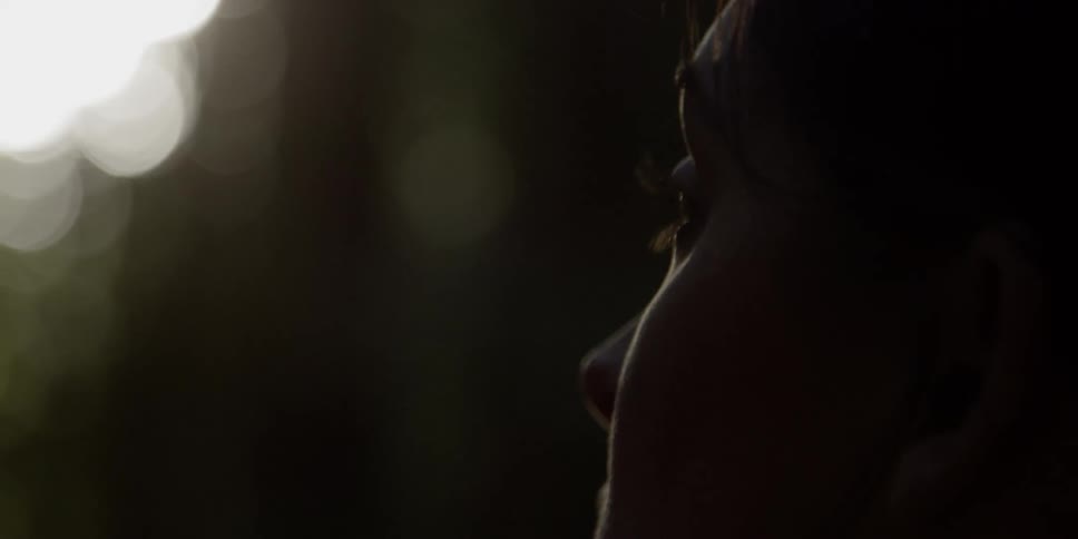 A woman looks around outside