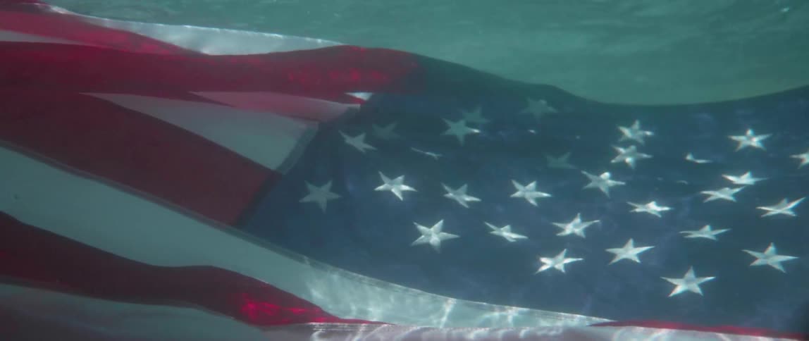 An american flag is submerged in water