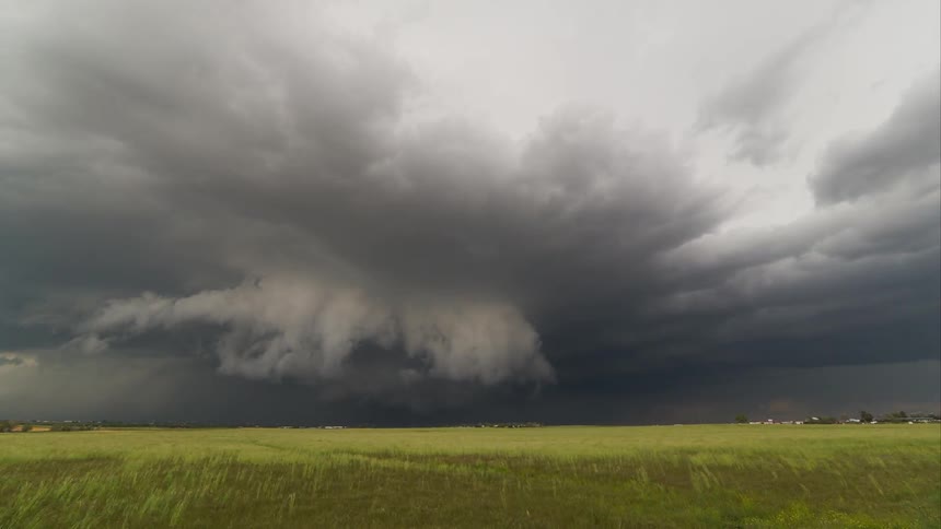Time lapse of storm clouds moving over a plain