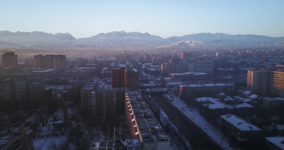 Large city with mountains in the distance on a clear day