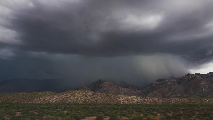 Storm clouds moving in over a mountainous area