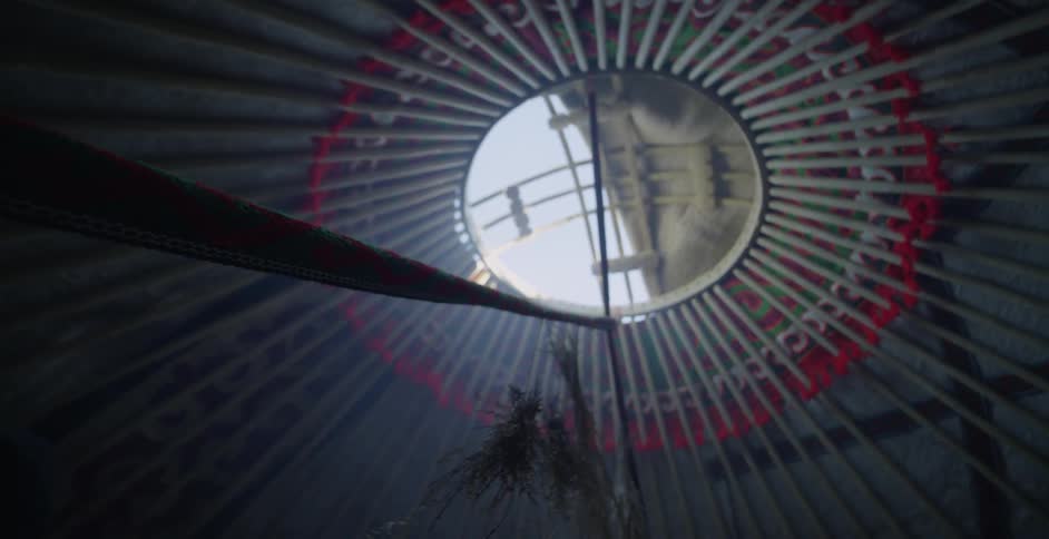 Grass hangs in a smoky yurt
