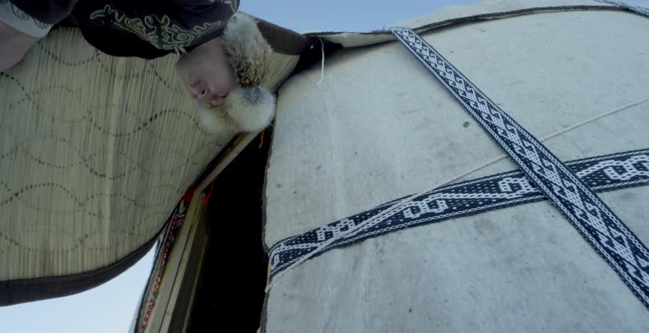 A man enters a yurt