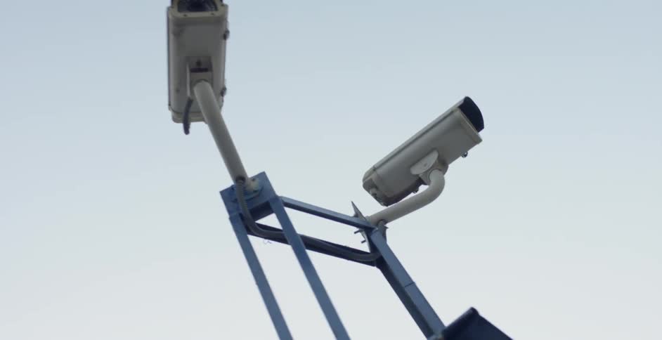 Camcorders sit on a building exterior