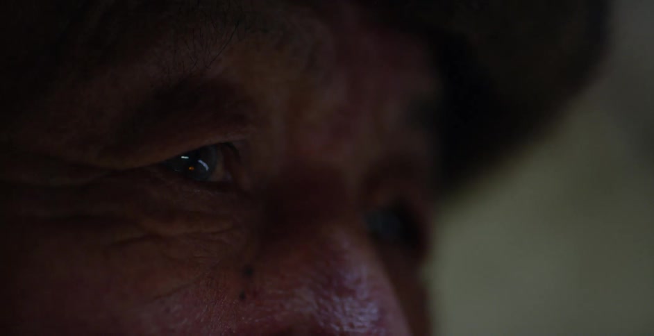 An elderly person looks around