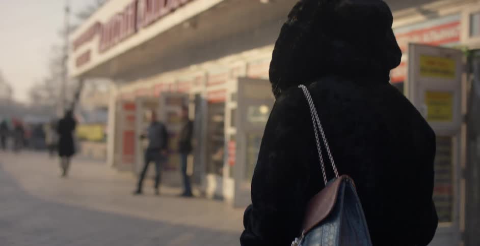 A woman walks outside a store