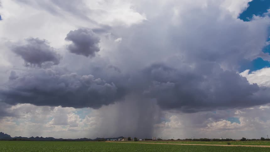 Time lapse of a cloudy sky dropping rain on a small area