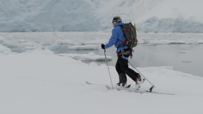 A man is skiing over a frozen landscape in daylight