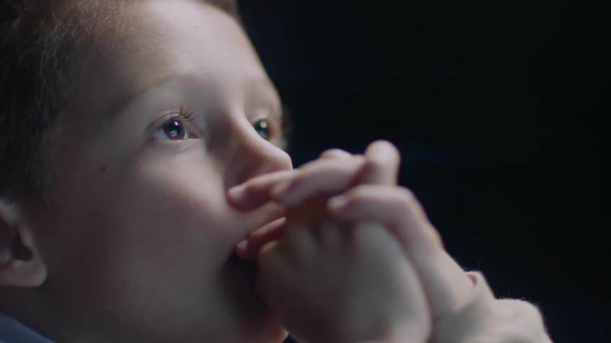 A young boy watches television
