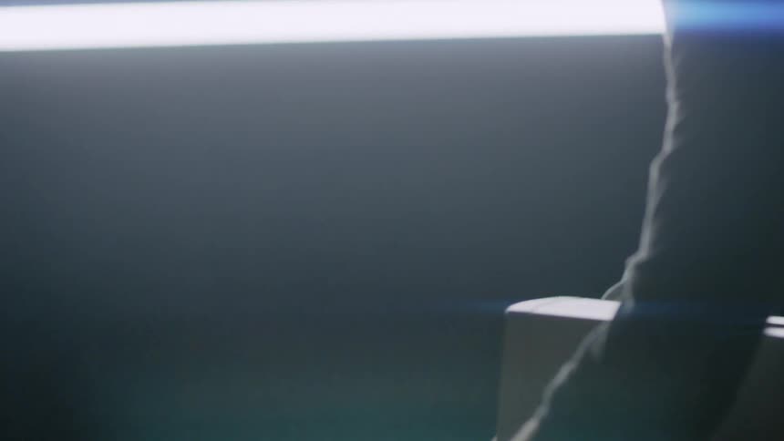 A man puts a keyboard on a desk
