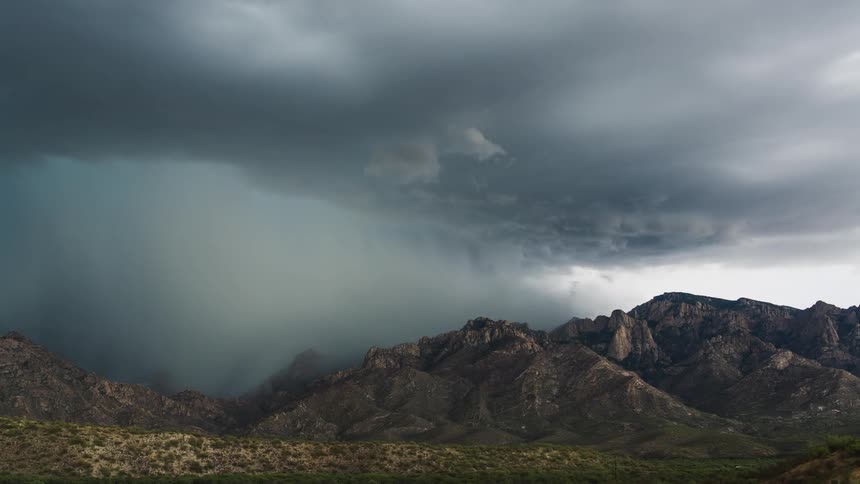 A scenery of a mountain range at stormy weather