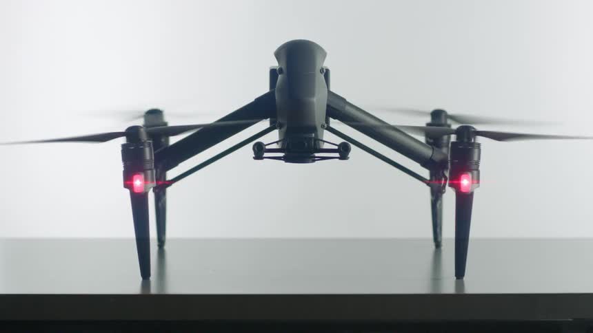 A drone is powering up as it rests on a countertop