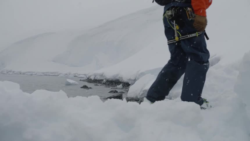A man hikes in the snow