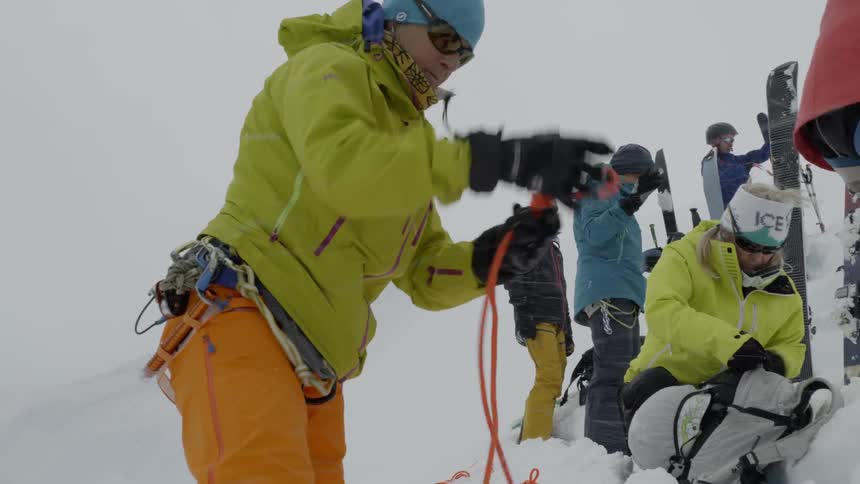 Group of people prepare to hike on snowy terrain