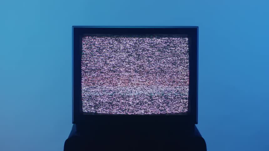 The small television screen is flickering static