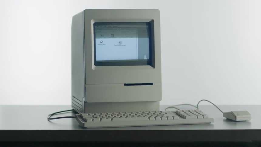 Old fashioned computer flashes a program on its screen