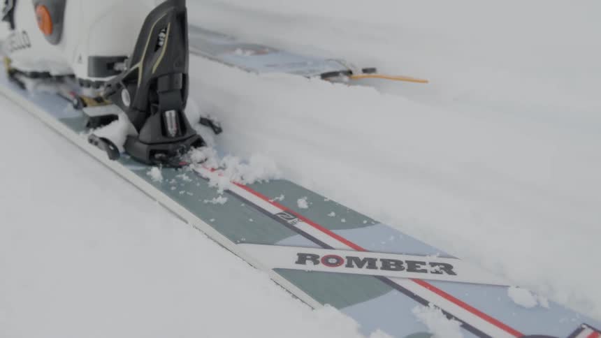 A person moves their skis slowly in the snow