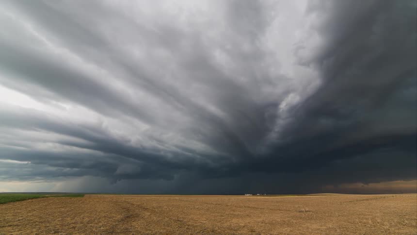 Time lapse of dark storm clouds moving over a rural area