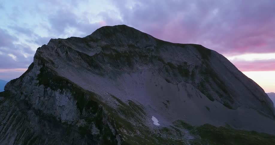 The mountain has thick clouds above