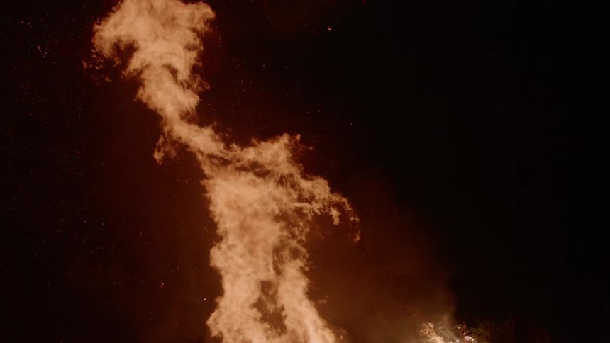 Fire blazing brightly outside at night
