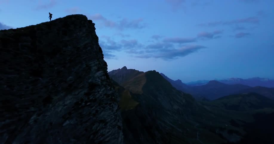 Man walks along the top of a mountain