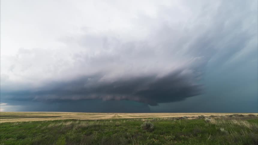 Time lapse of some heavy clouds slowly forming a tornado