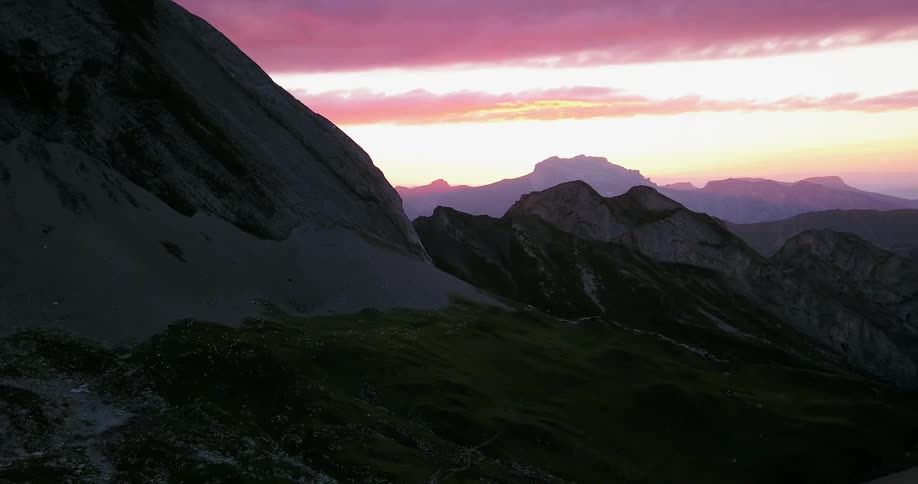 Mountains sit under a cloudy sky