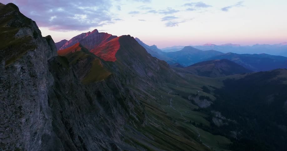 Mountains sit under a cloudy sky