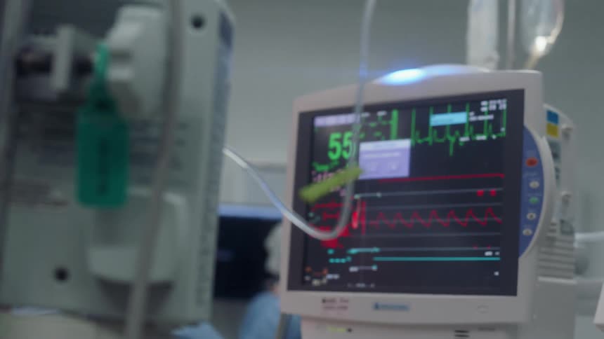The hospital monitor flashes with patient information