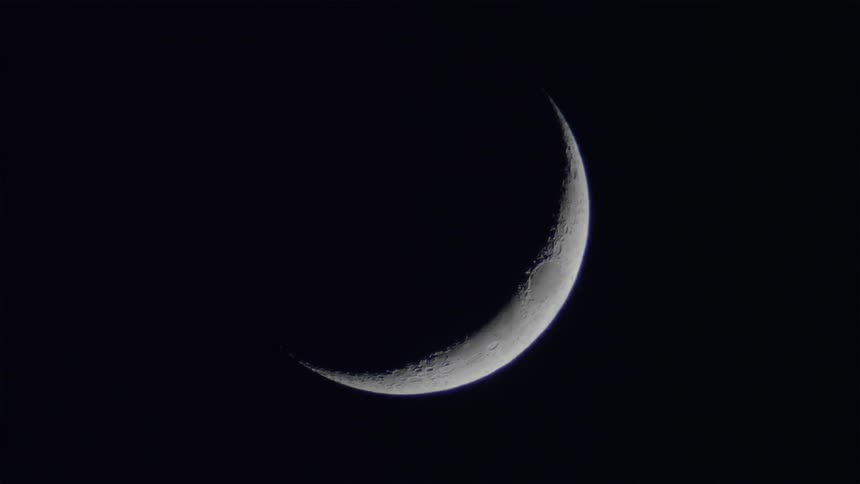 A crescent moon glows at night